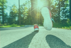 Image of a person running on a paved path